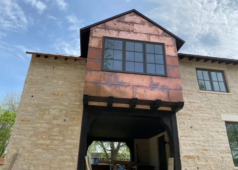 Copper metal panel facade on a stone building for Skylight Installation in Foothill Farms