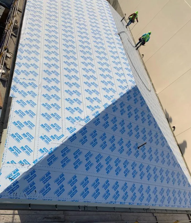 Professional roofers installing underlayment on a metal roof in Foothill Farms